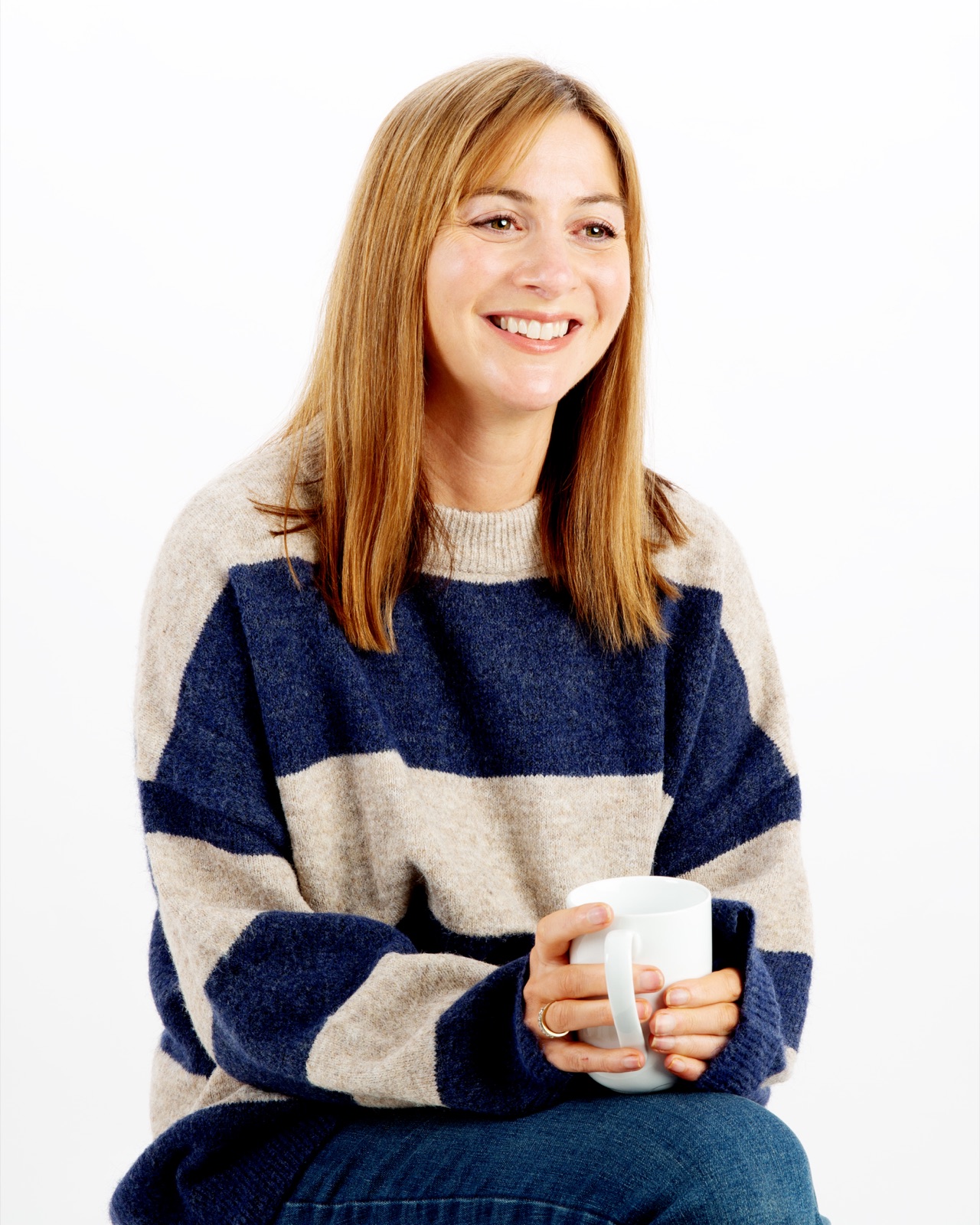 Jen Ellison smiling with a cup of tea